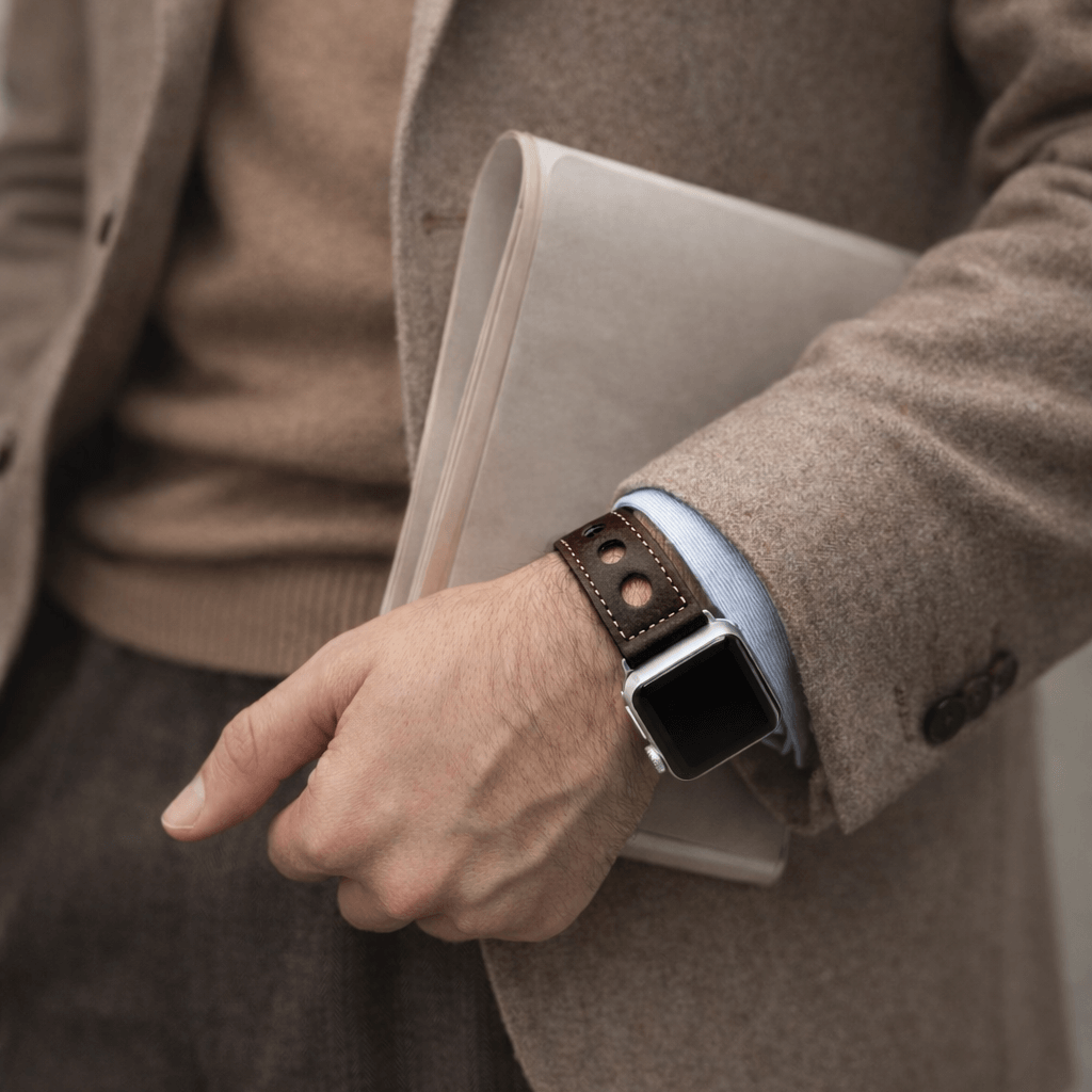 Mann trägt ein dunkelbraunes Rallye Apple Watch Lederarmband im Panerai-Stil mit markanten Lochungen und edlem Design.