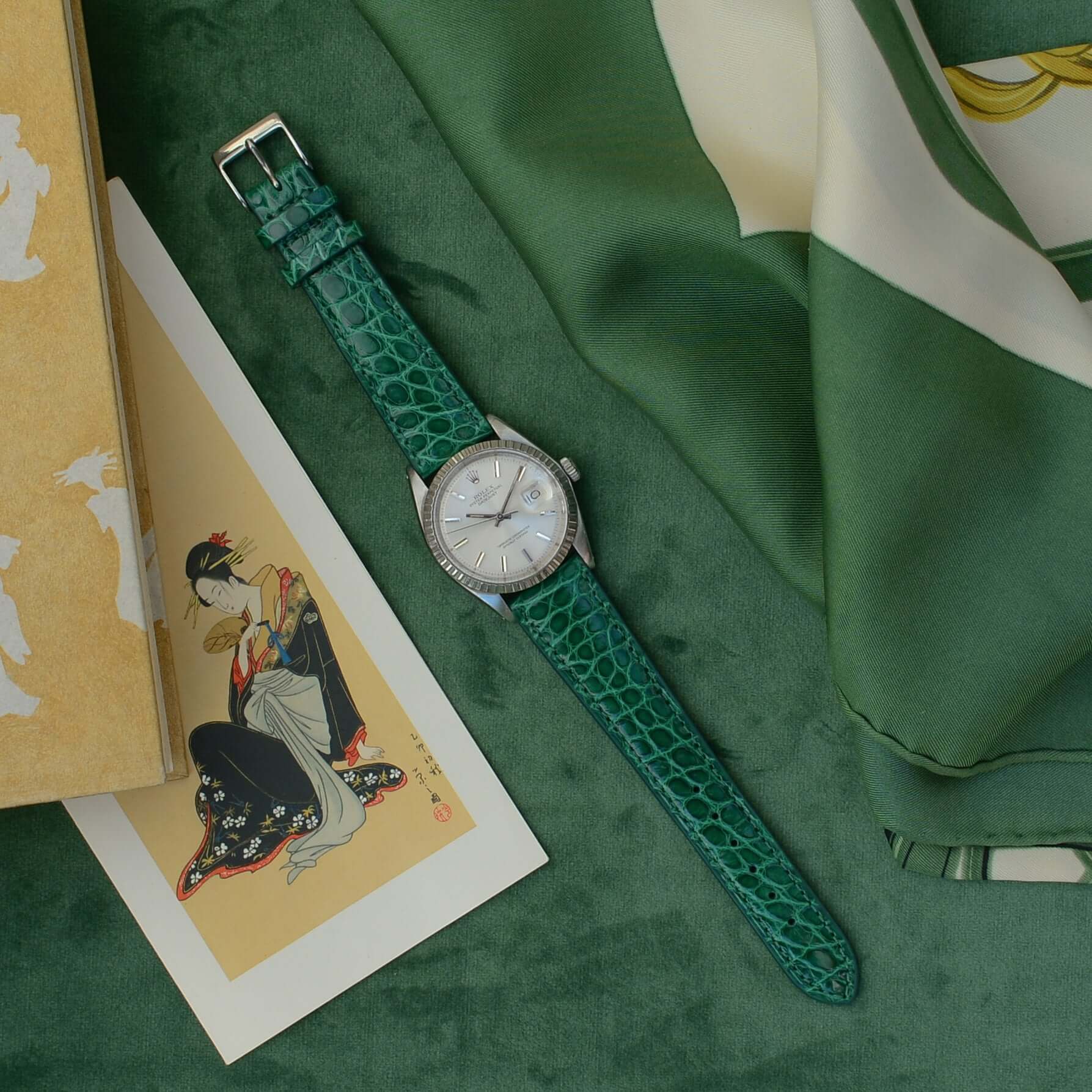 Luxus Uhr mit Glänzendes Kroko Armband aus grünem Krokodilleder, präsentiert auf edlem, grünem Hintergrund, umgeben von feinen Details.