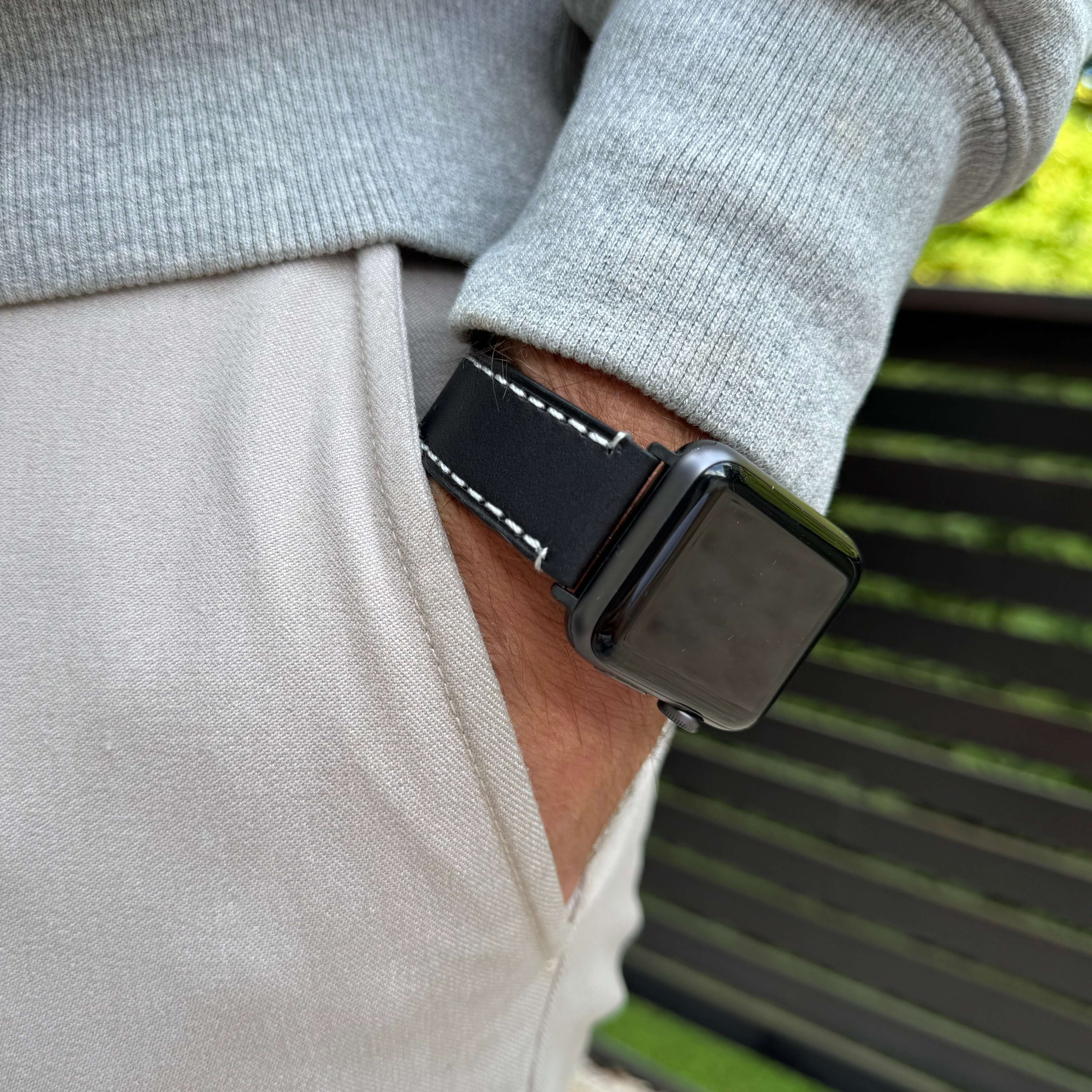 Extra Breites 24mm BIO-Leder Armband für Apple Watch Ultra, handgefertigt in Deutschland, getragen am Handgelenk mit grauem Pullover.