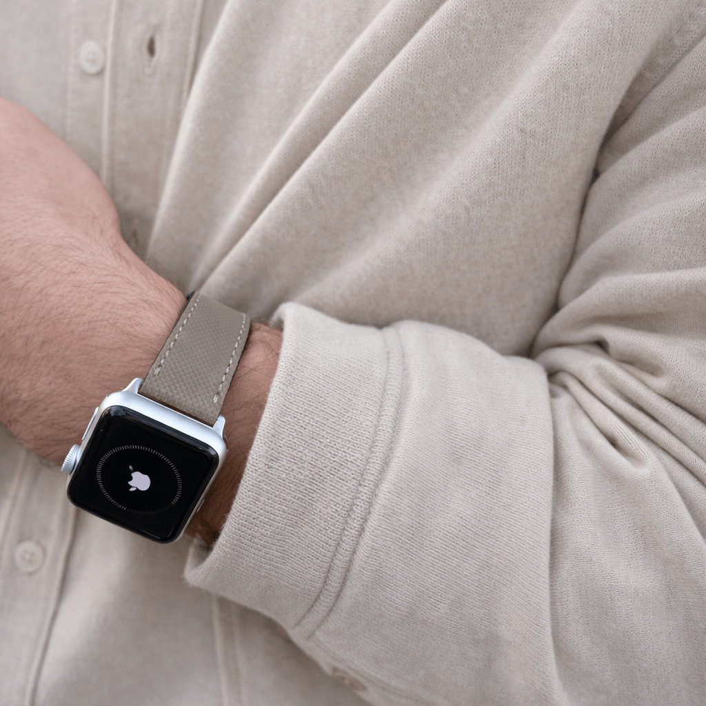 Beiges Apple Watch Lederarmband Wasserfest | Nautilus, getragen von einer Person, passend für sportliche und alltägliche Aktivitäten.