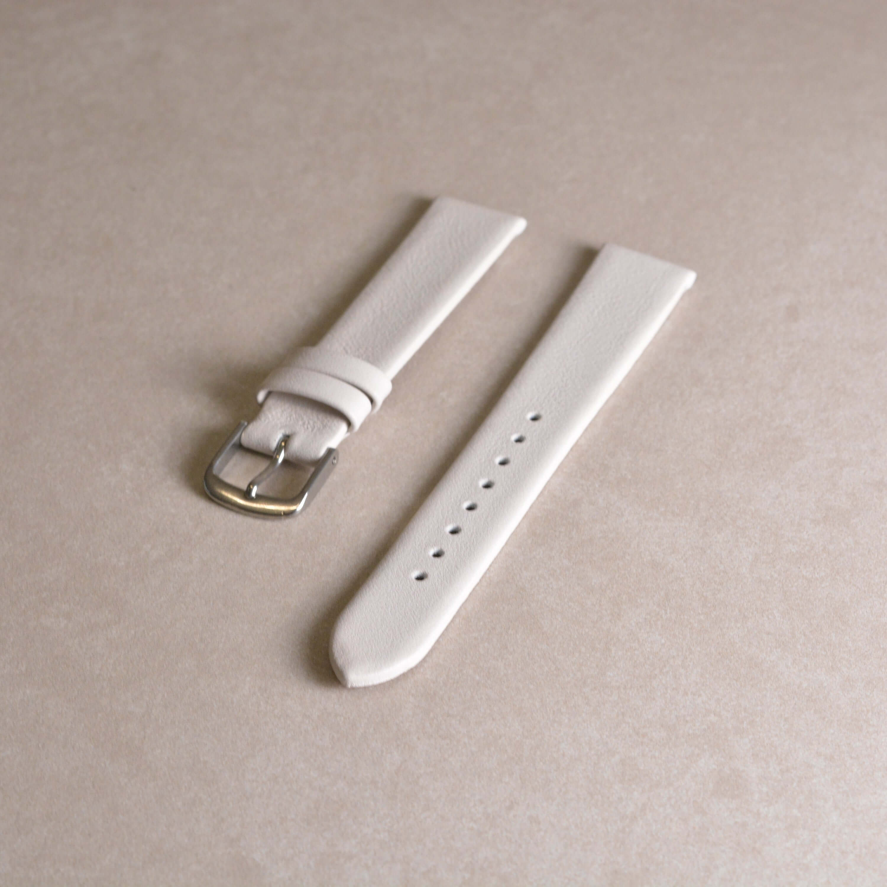 17mm Uhrenarmband aus glattem Kalbleder - passend für Junghans Uhren, weißes Lederband auf beigem Hintergrund