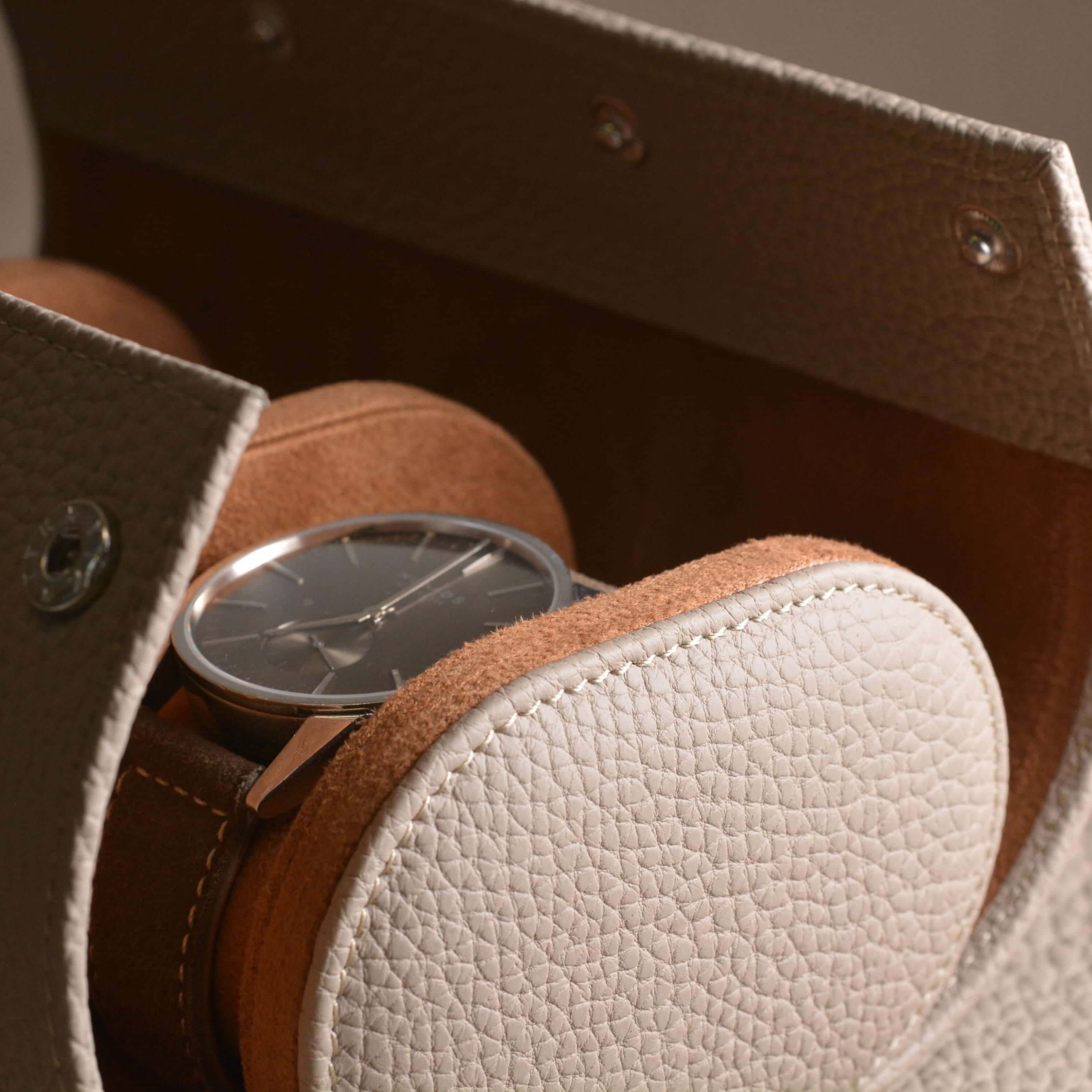 Luxurious Togo leather watch roll holding a stylish watch, highlighting the elegant craftsmanship and design for watch storage.