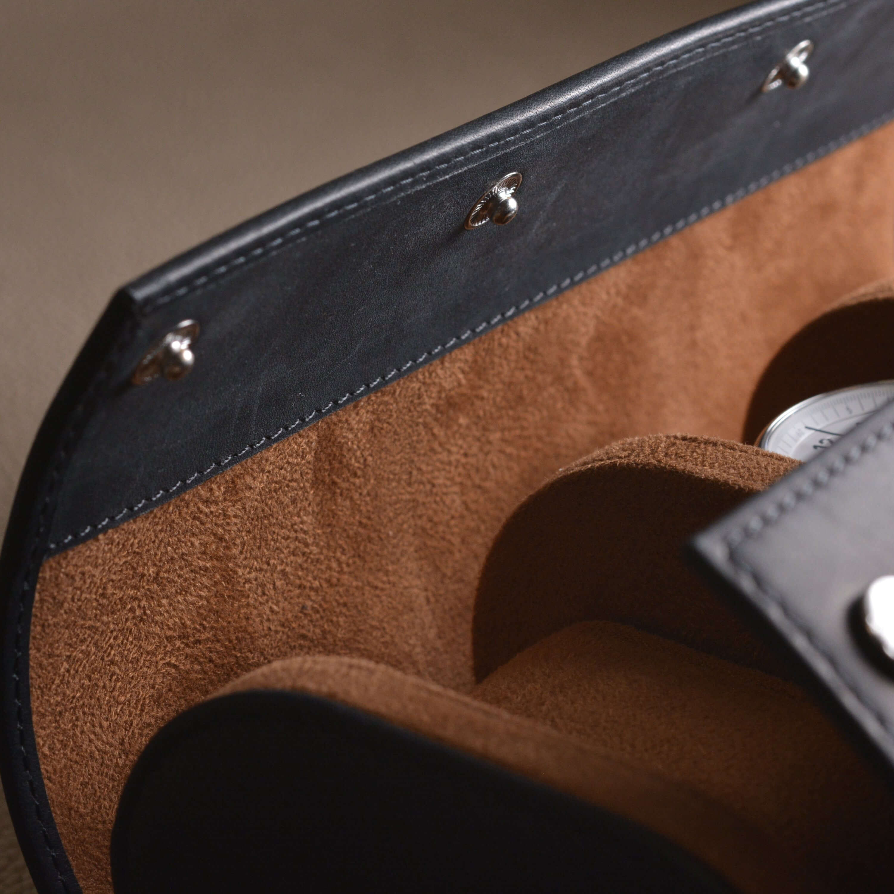 Detail of 3er Uhrenrolle aus hochwertigem Barenia Leder, ideal for protecting watches, with sleek leather finish and elegant craftsmanship.