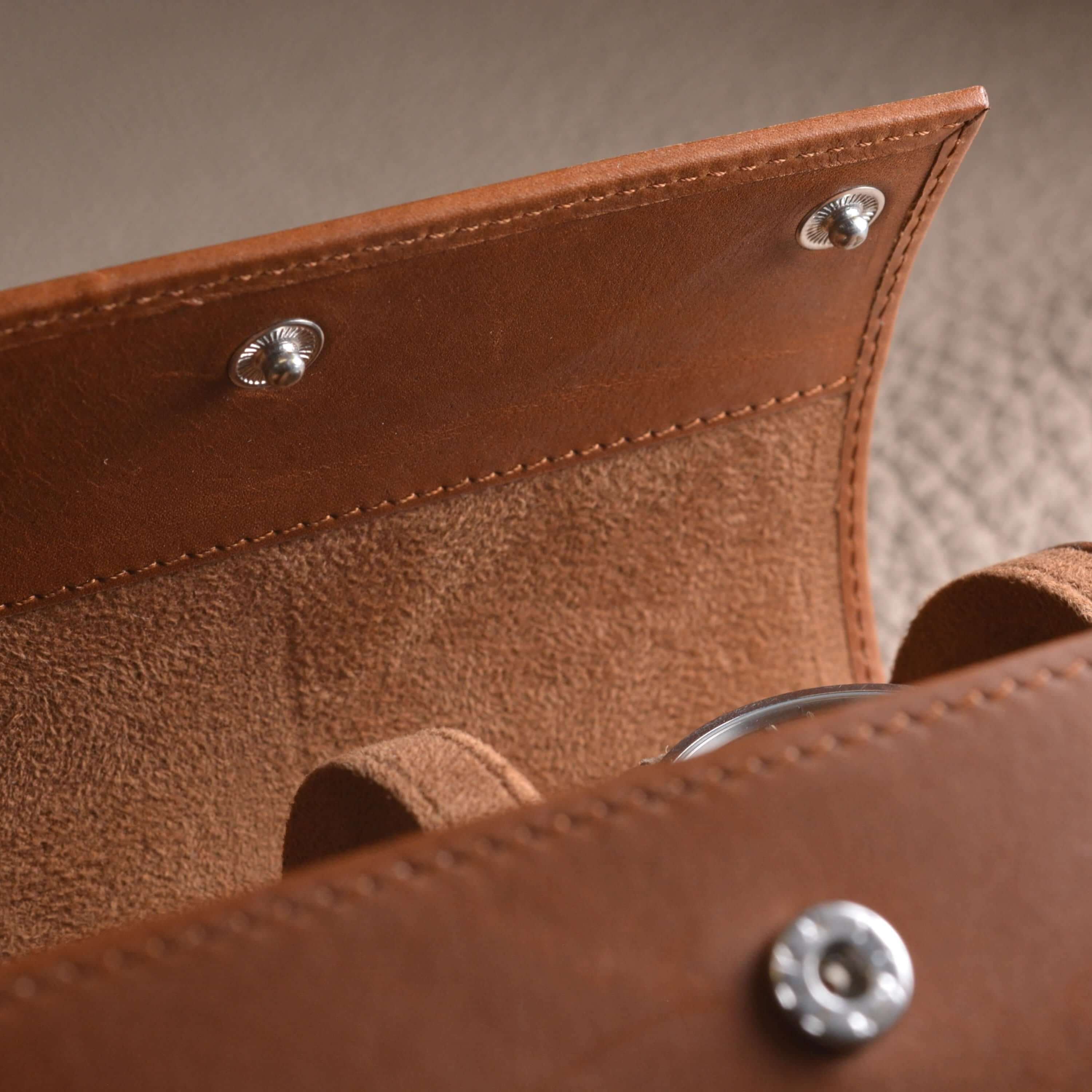Detail of handcrafted Barenia leather watch roll, showing luxurious smooth texture and secure closure.