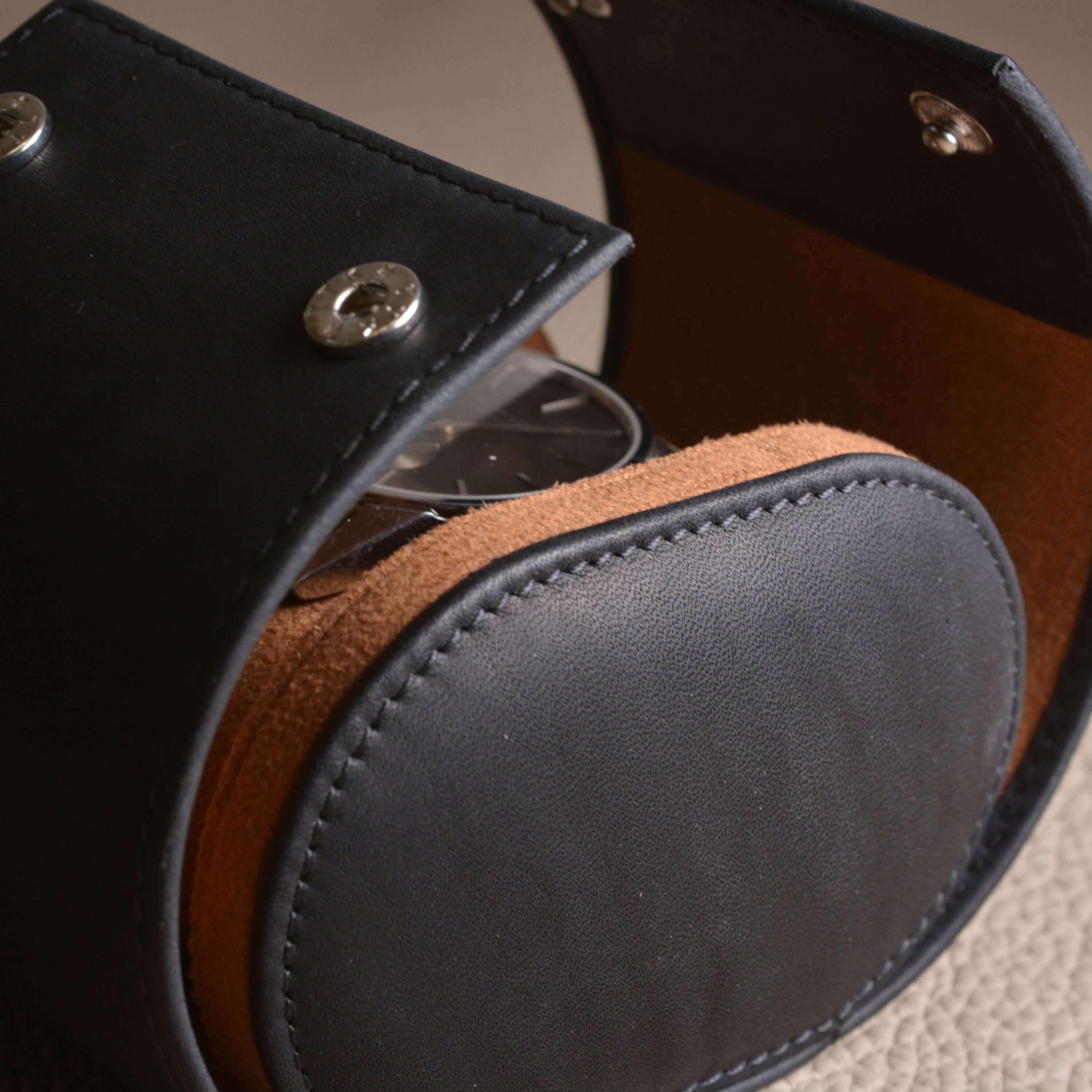 Luxurious handmade leather watch roll in dark brown, perfect for one watch, showcasing elegant design and craftsmanship.