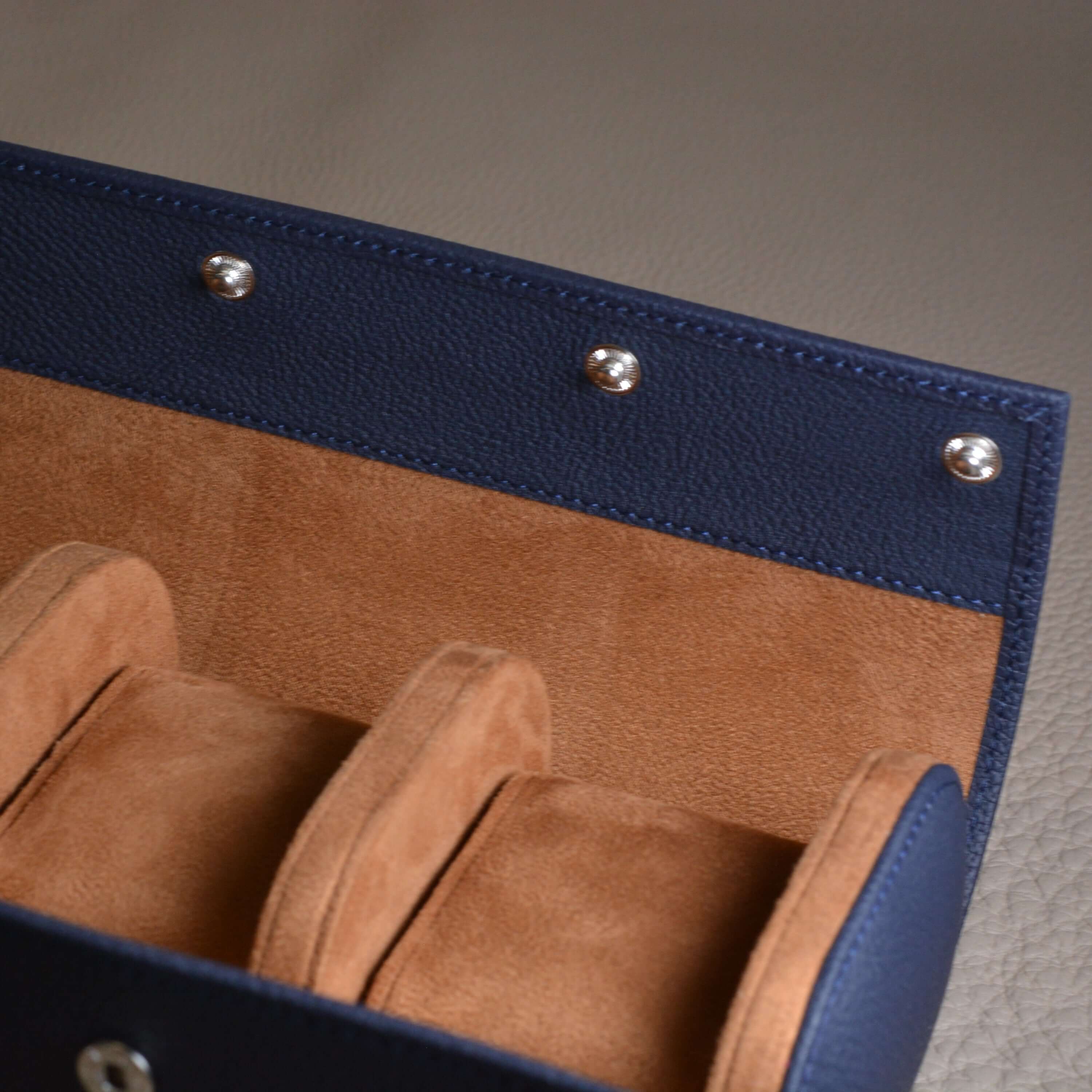 Luxurious hand-crafted Togo leather watch roll for safe storage of three watches, featuring high-quality craftsmanship.