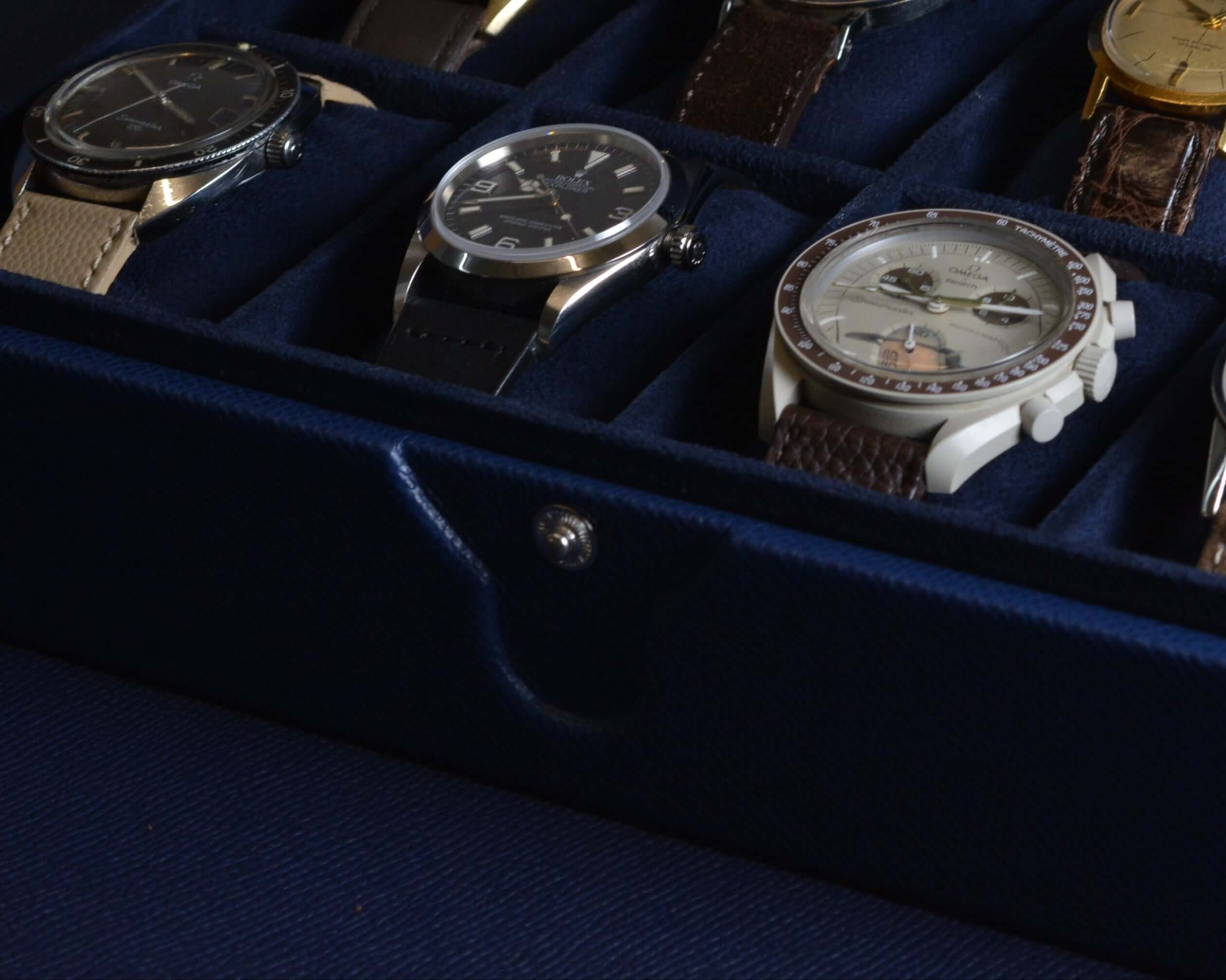 Luxury wristwatch collection in velvet case with elegant designs and leather straps.