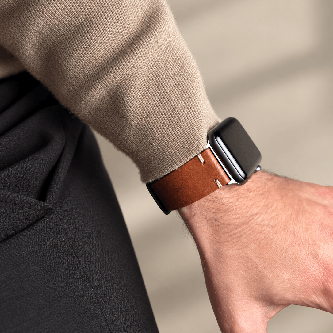Hunter Apple Watch Armband Leder Hellbraun am Handgelenk in Kombination mit einem beigen Pullover.