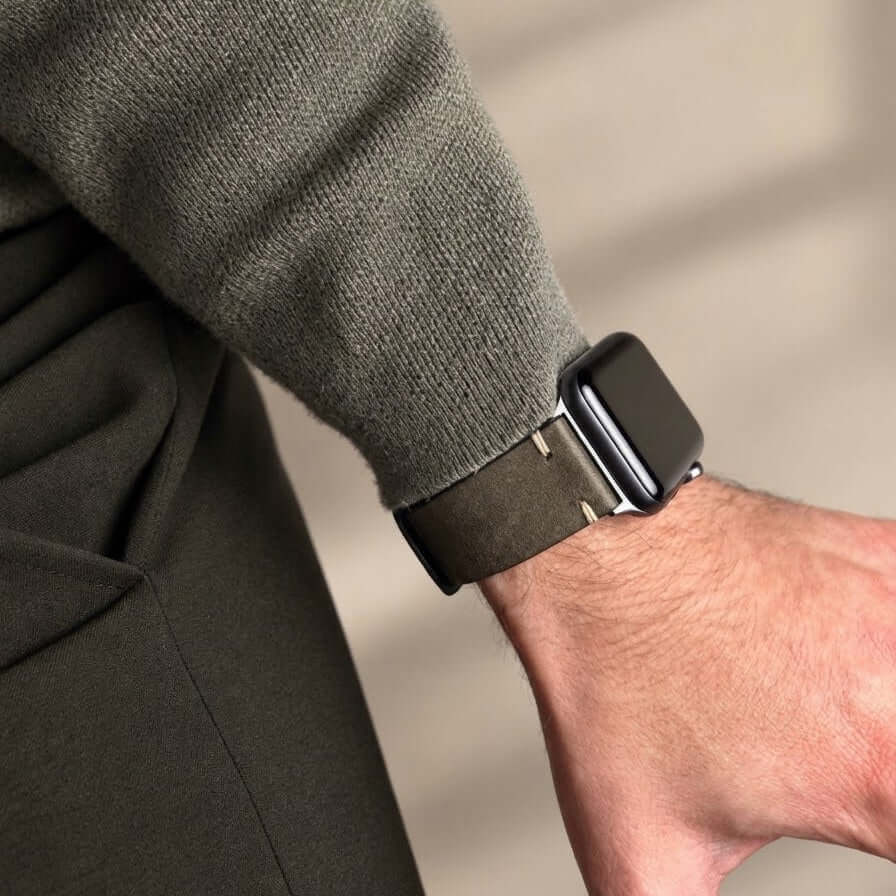 Hunter Apple Watch Armband Leder Olive an einem Handgelenk, kombiniert mit einem stilvollen Outfit in Olivtönen.