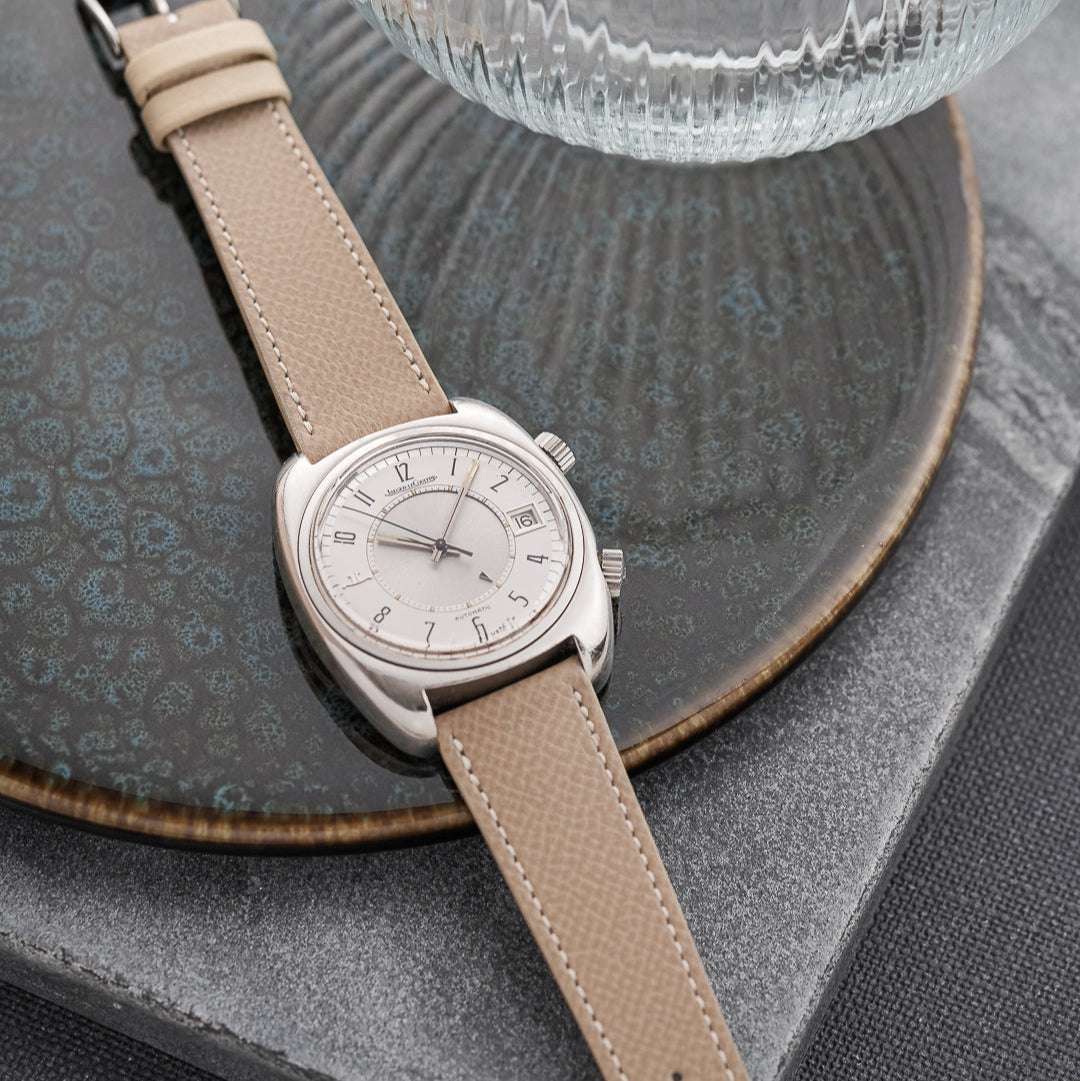 Beiges Uhrenarmband aus hochwertigem Leder an Jaeger-LeCoultre Memovox – Detailaufnahme des Armbands an der ikonischen Uhr, elegantes Design, strapazierfähig und luxuriös