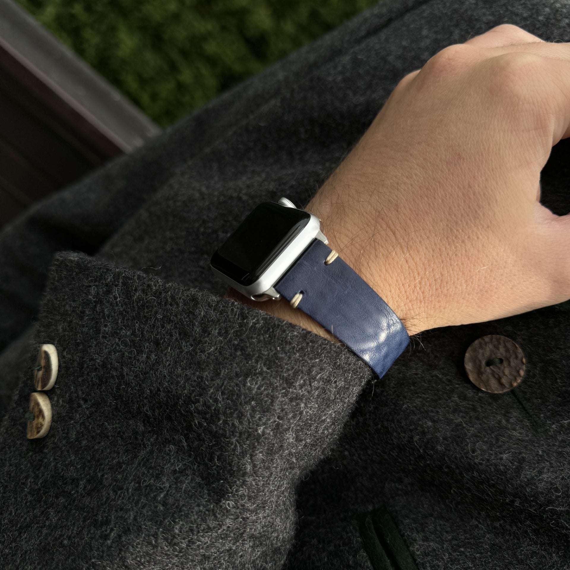 Nahaufnahme des blauen Apple Watch Armband Leder Herren am Handgelenk eines Trägers in stylischer Kleidung.