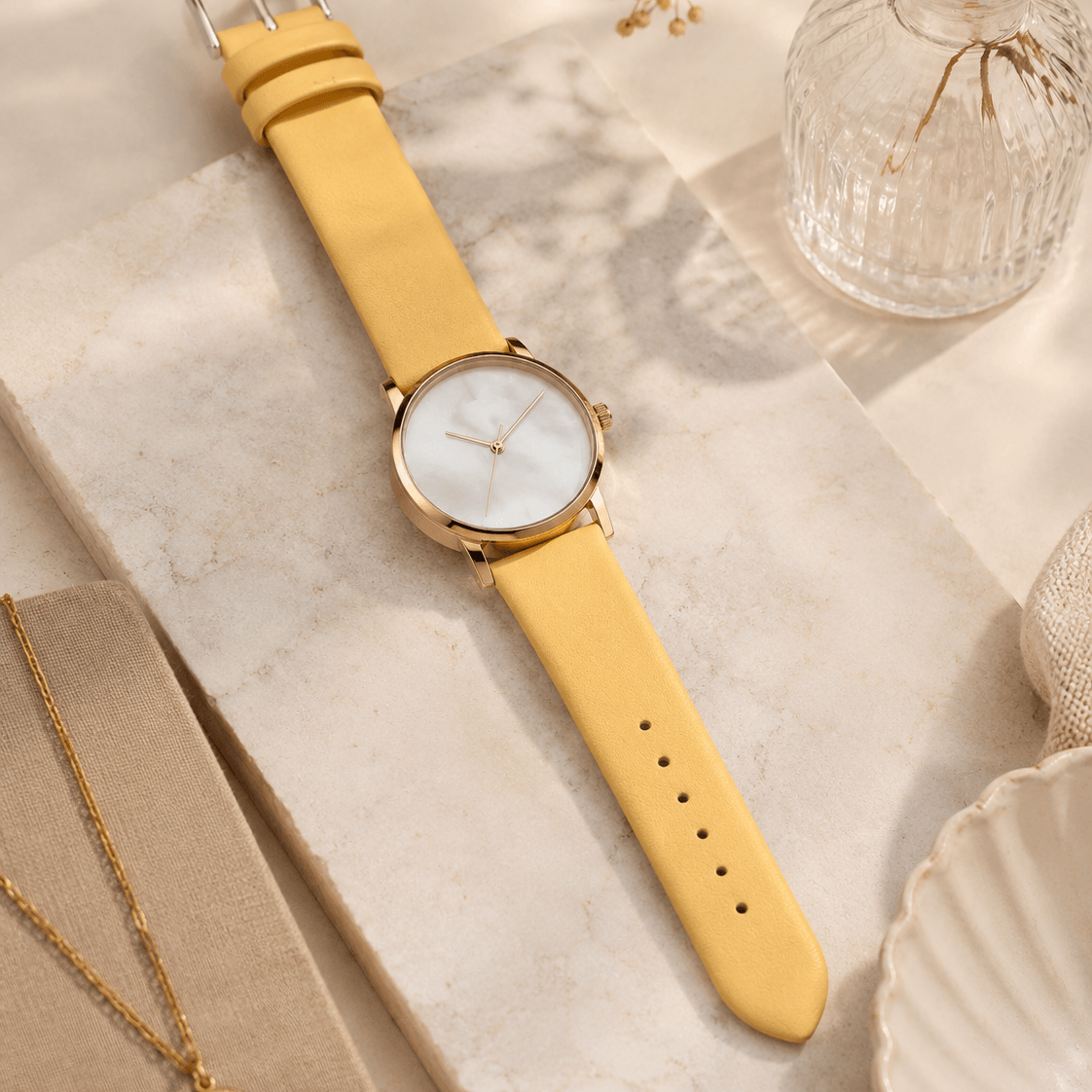 Holiday – Feines Uhrenarmband aus Leder für Damenuhren in elegantem Gelb auf Marmorplatte.