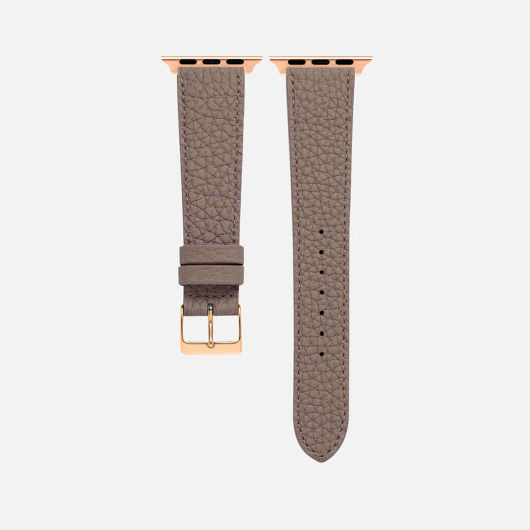 Taupes Lederarmband für Apple Watch aus Togoleder mit charakteristischer Narbung und goldfarbener Schnalle.