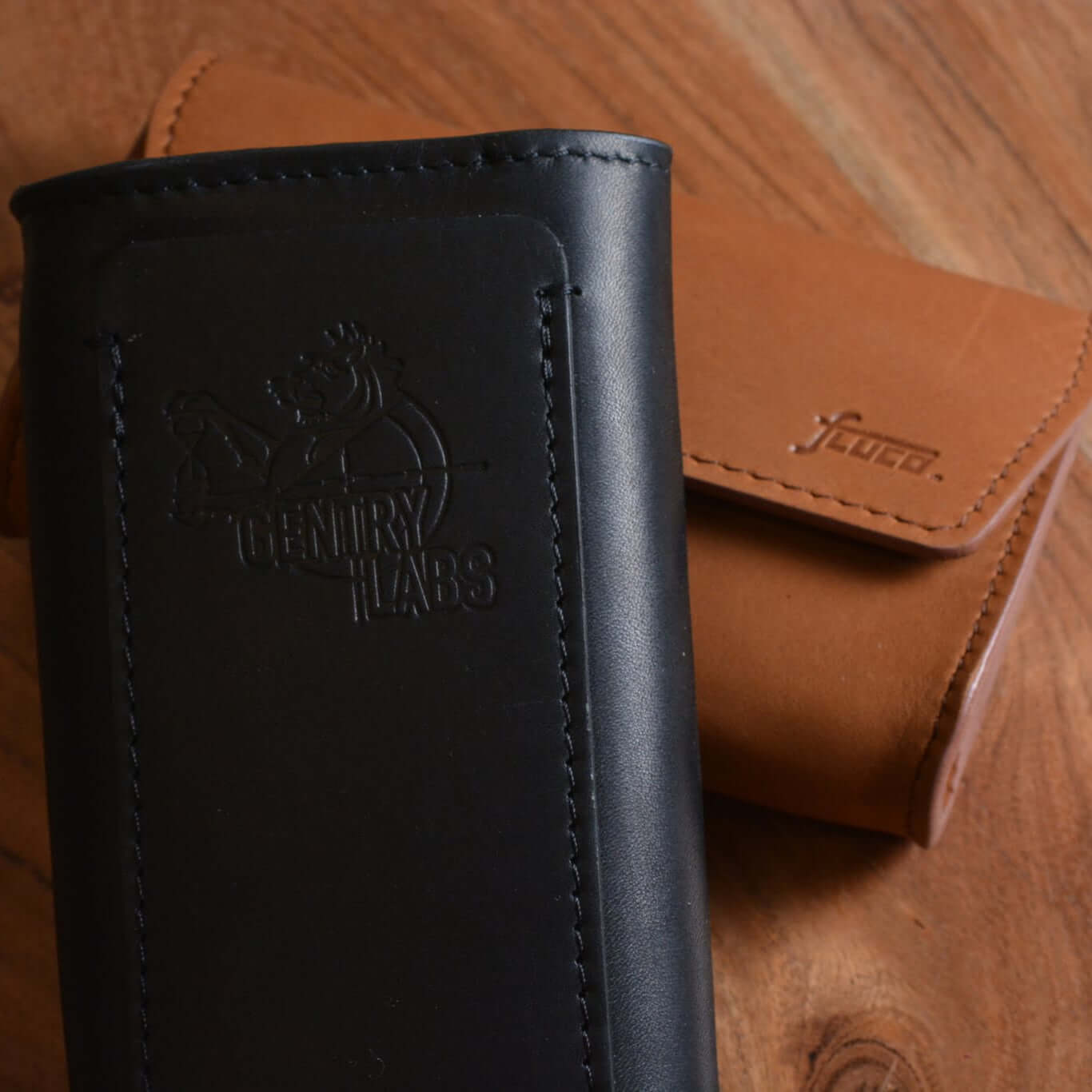 FLUCO x The Urban Gentry Pocket Watch Case in leather, featuring compact design for travel, displayed on a wooden surface.